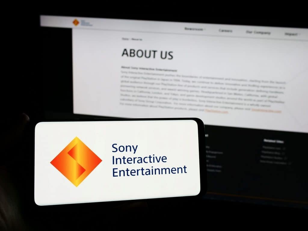 Sony Interactive Entertainment soon in a smartphone; Behind, a text on the company displayed on the screen of a notebook